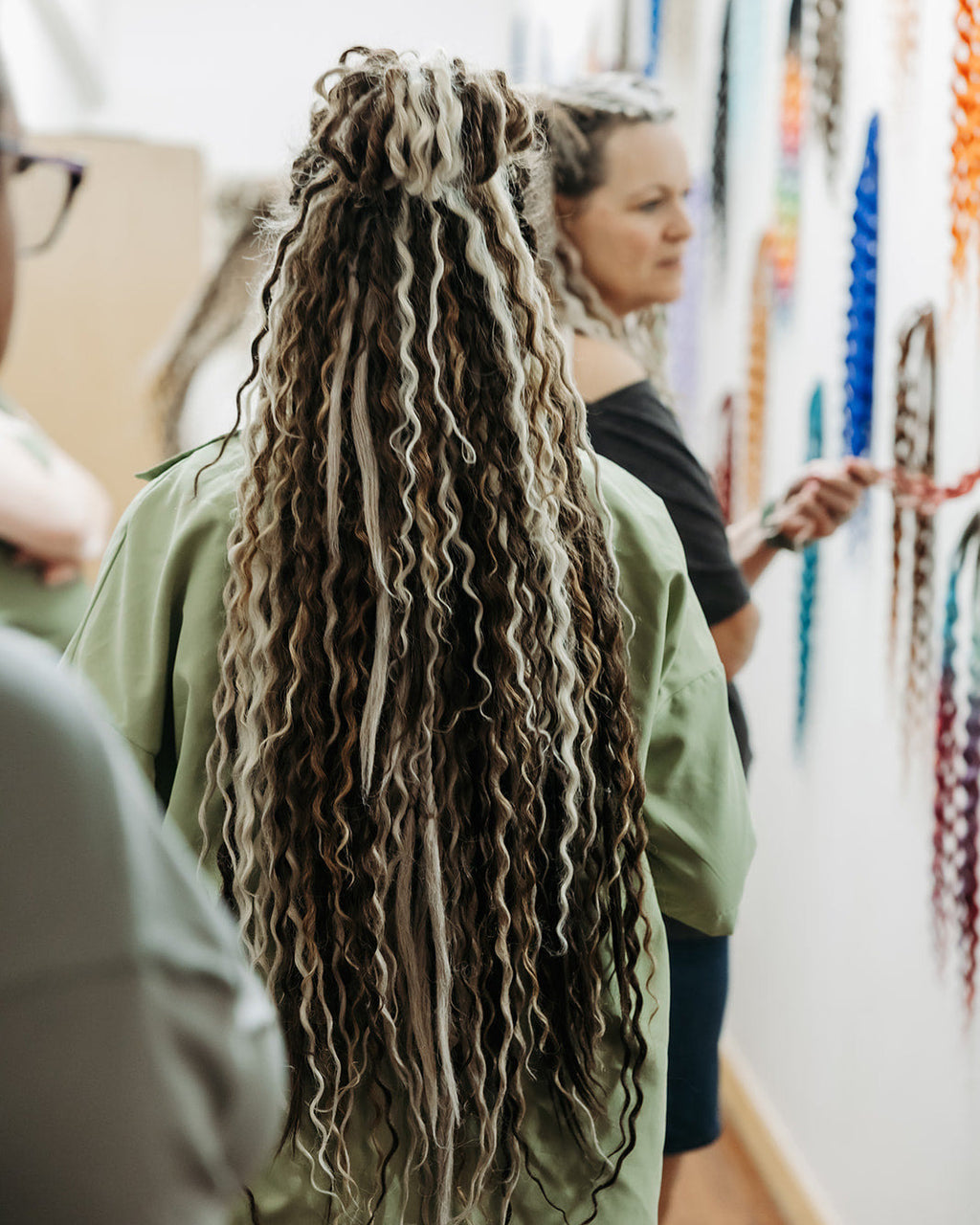 Person with Venus Long Braid-in Hair Extensions in a store setting