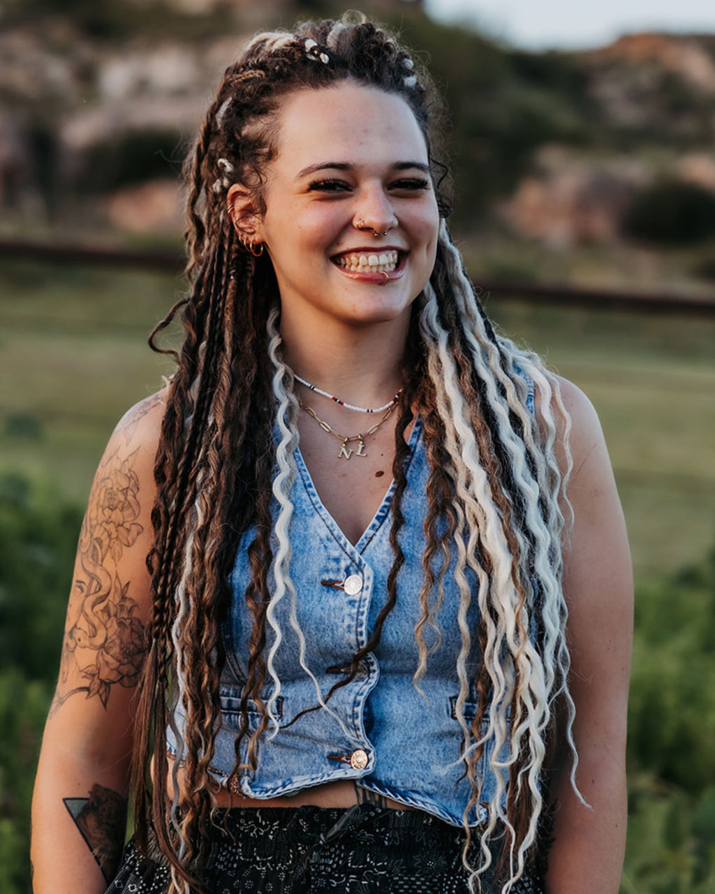 Woman with Venus Long Braid-in Hair Extensions smiling outdoors