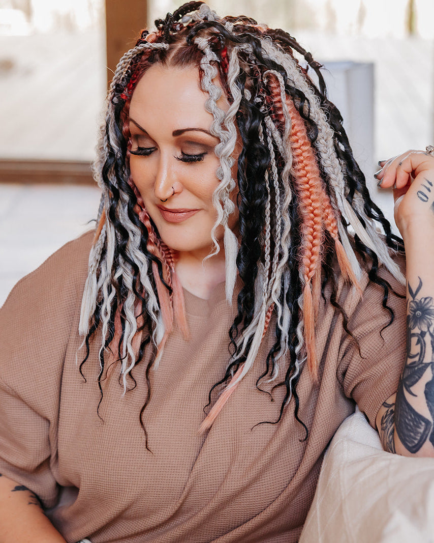 Girl with braid in hair extensions and various textures and braids.