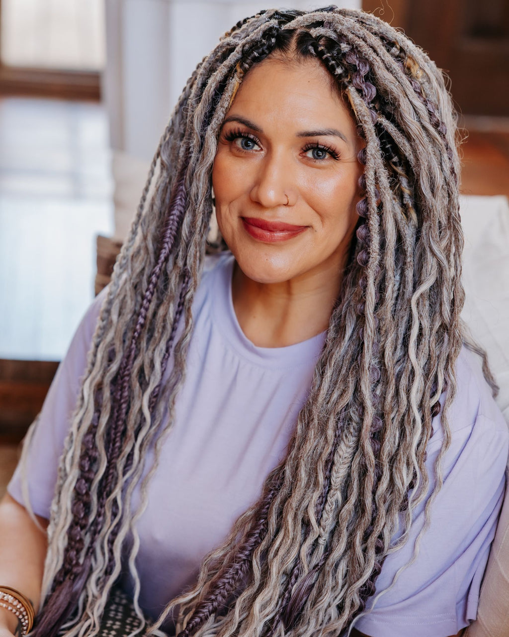 Woman with long, braided hair in a casual setting