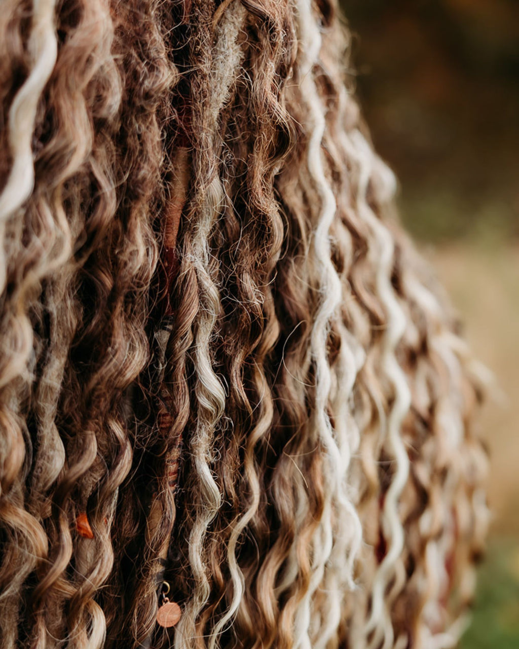 Close-up of Venus Long Braid-in Hair Extensions with a blurred natural background