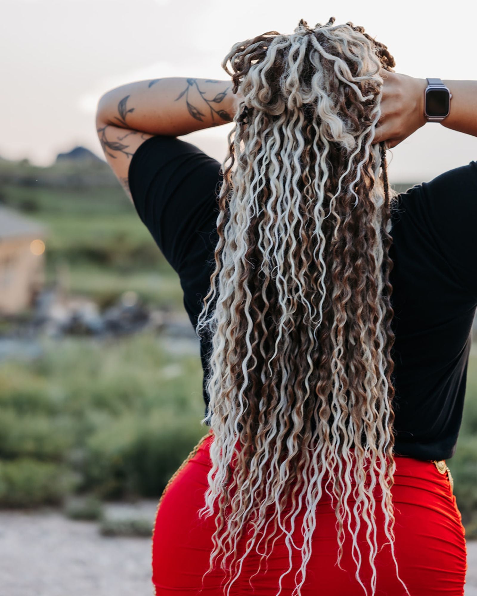 Person with Venus Long braid-in Hair extensions in a natural outdoor setting