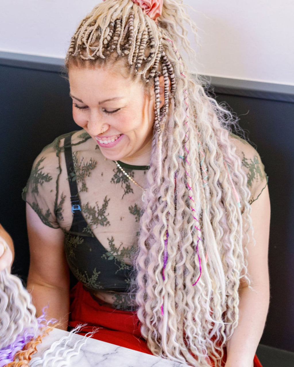 Woman with Venus Long Braid-in Extensions sitting indoors