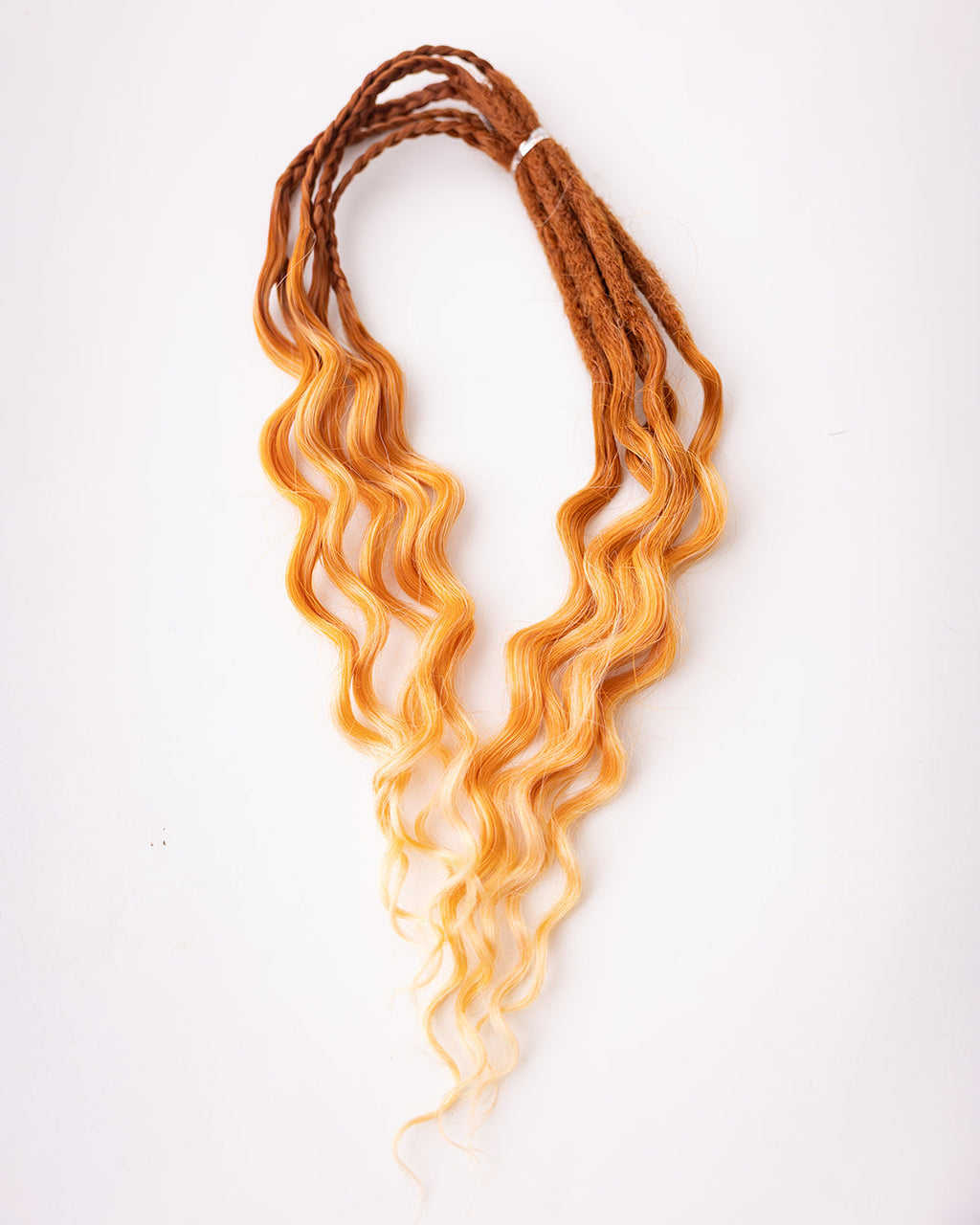 A bundle of short, wavy synthetic dreadlocks transitioning from rich auburn at the roots to a warm golden blonde at the tips, displayed on a clean white background.
