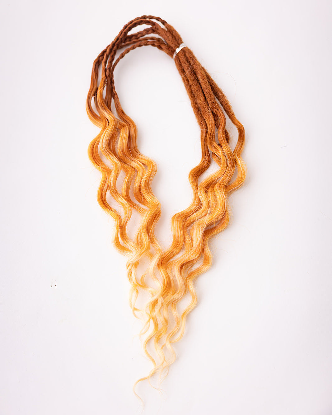 A bundle of short, wavy synthetic dreadlocks transitioning from rich auburn at the roots to a warm golden blonde at the tips, displayed on a clean white background.