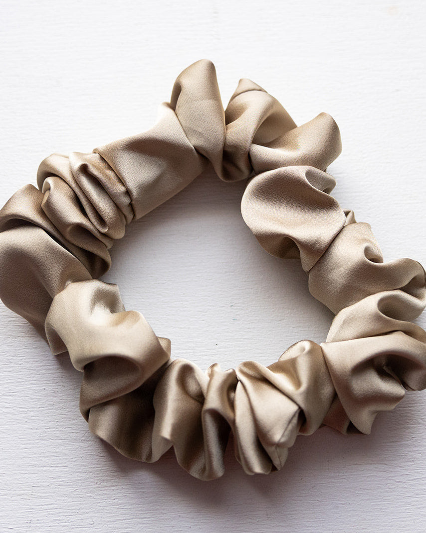 Beige scrunchie on a white background