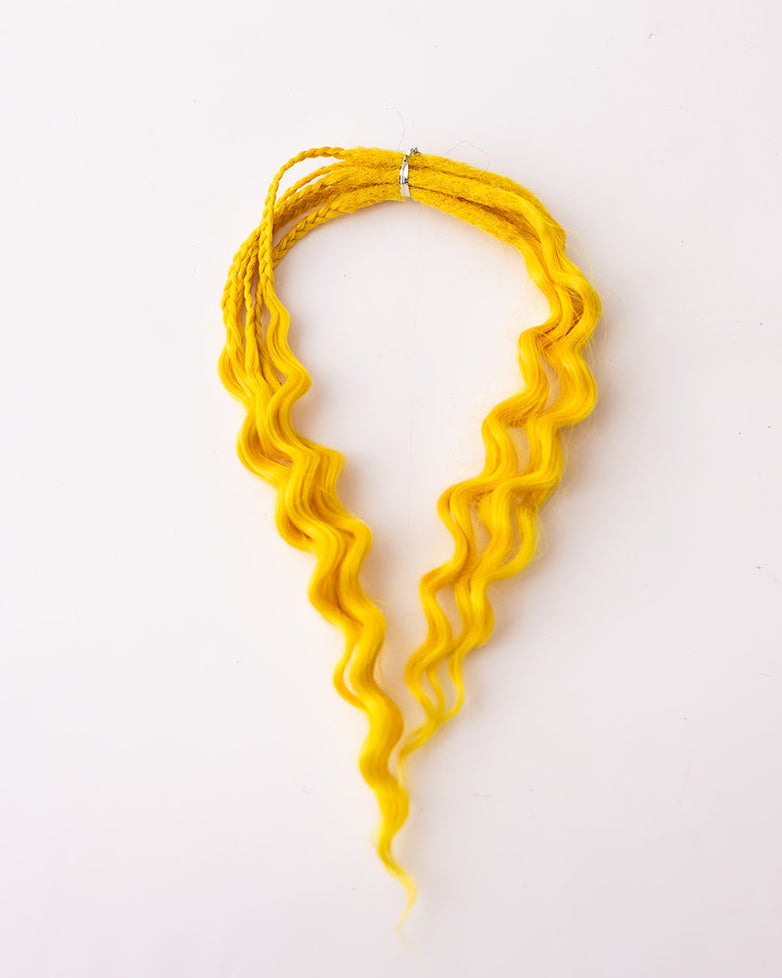 A bright yellow wavy synthetic dreadlock hair extension bundle, displayed on a clean white background.