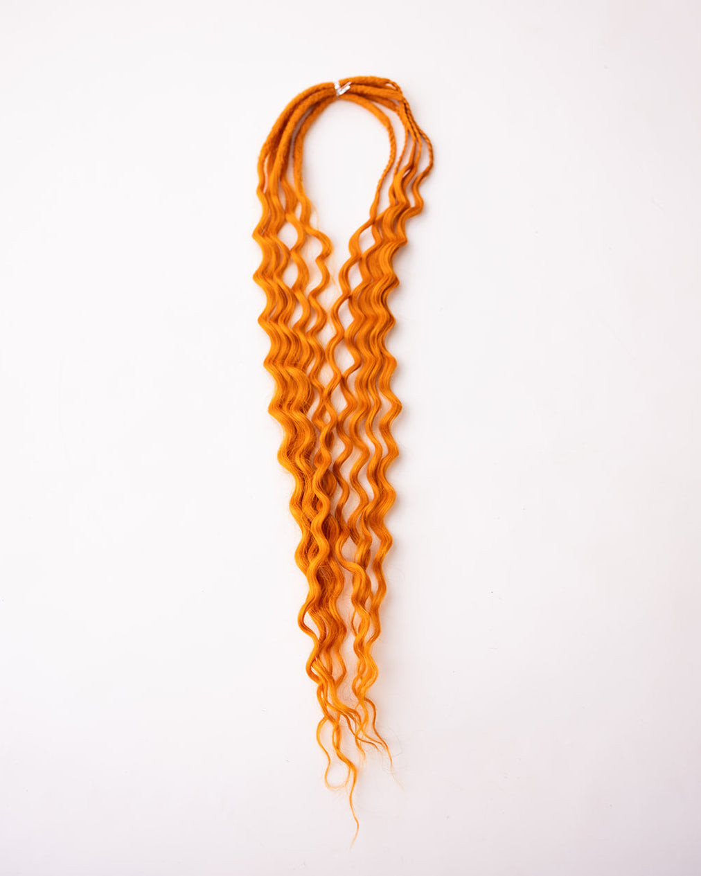 Bright orange synthetic wavy dread extension bundle, displayed vertically against a clean white background.