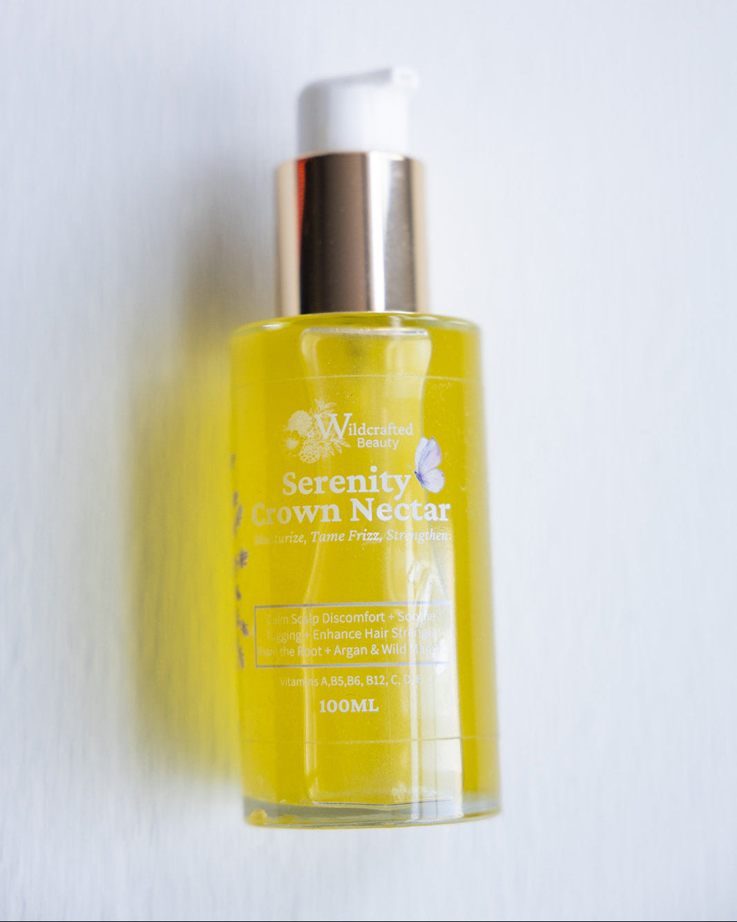 A 100ml bottle of Serenity Crown Nectar hair moisturizer with a lavender chamomile scent, displaying product information on its label.