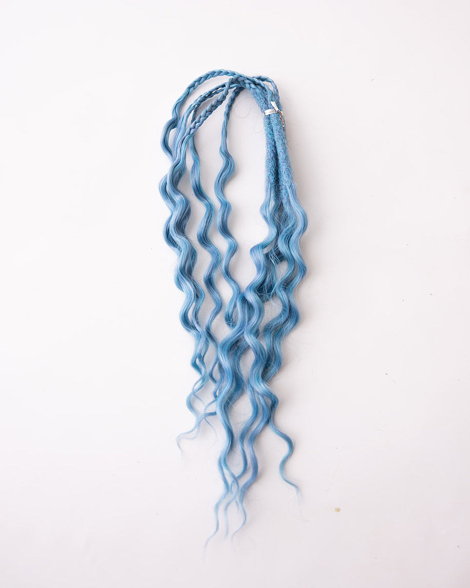 Medium blue synthetic wavy hair extensions with braided details at the top, displayed against a plain white background.