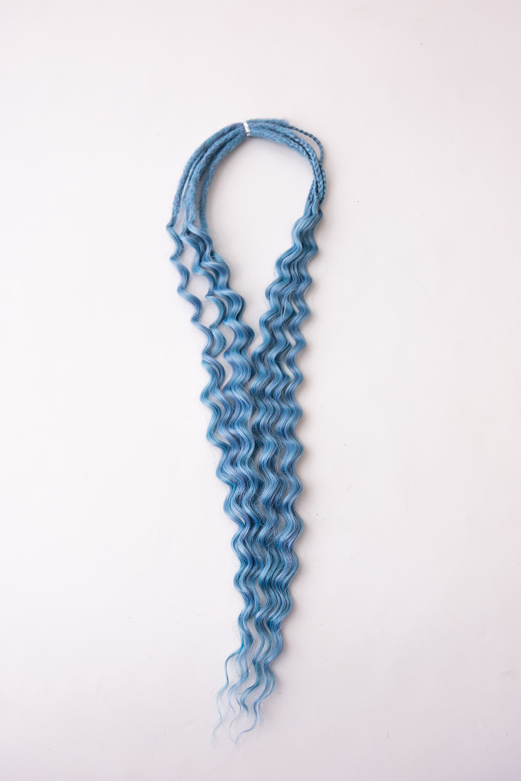 Medium blue curly extension hair bundle, displayed against a plain white background.