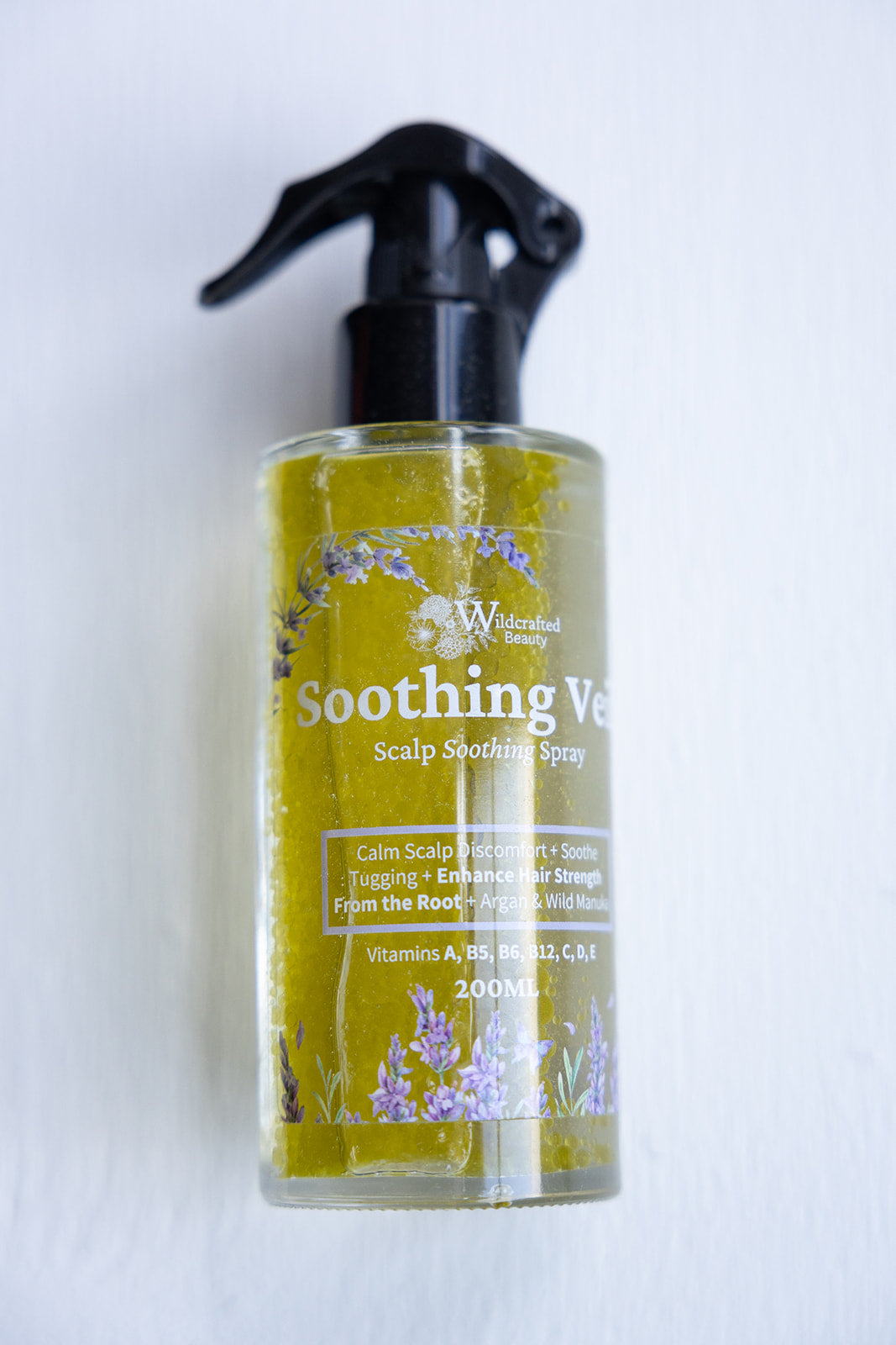 A 200ml bottle of Soothing Veil scalp soothing spray with a spray nozzle, labeled for hair and scalp care.