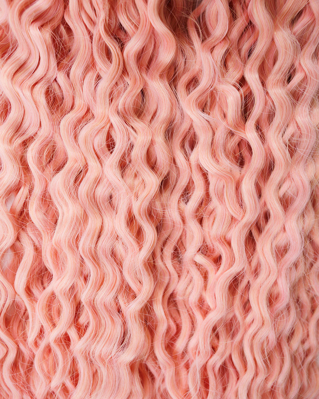 Close-up of pink hair extensions with wavy texture