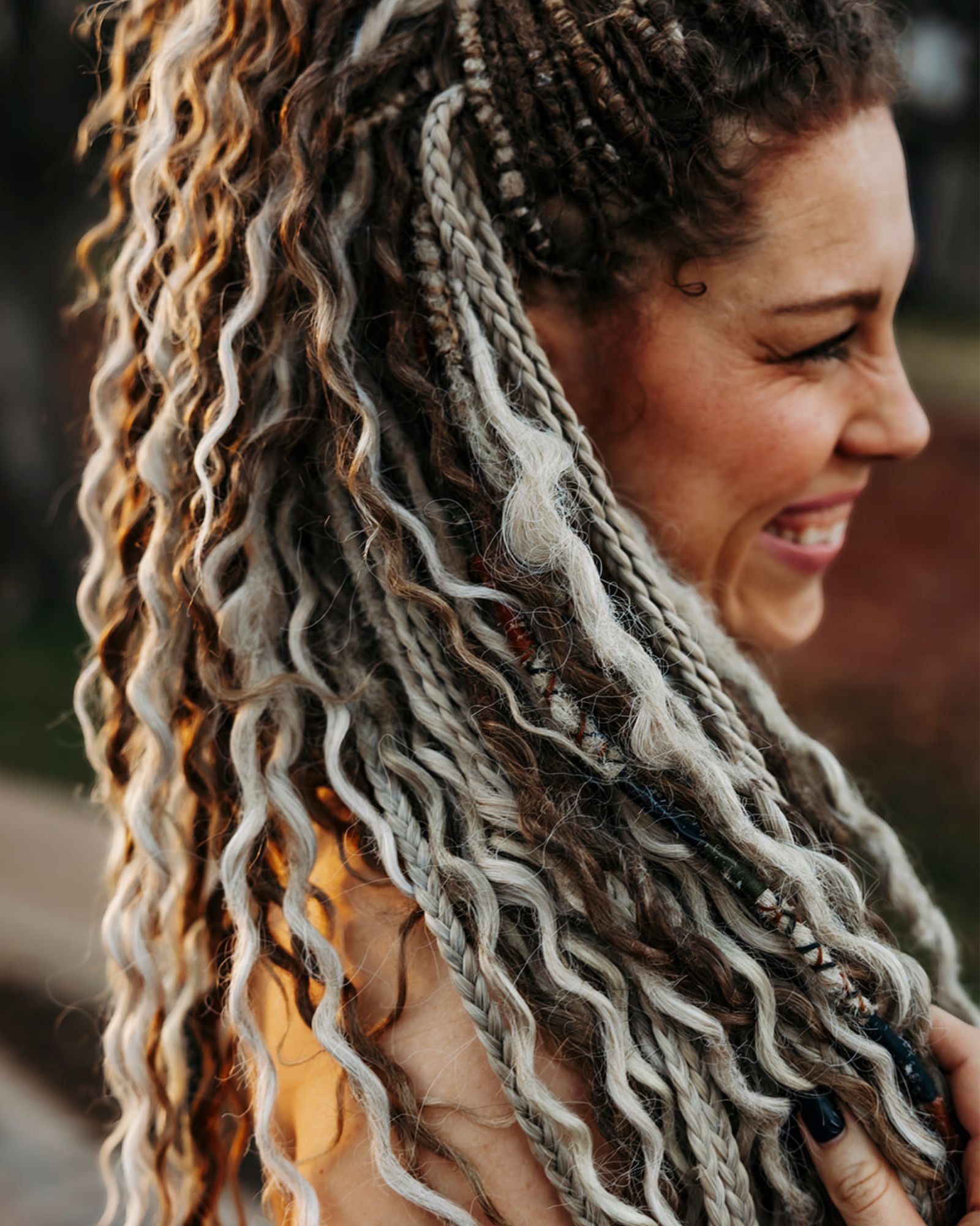 Woman with Venus Long Braid-in Extensions smiling outdoors